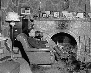 John Joseph Matthews (c. 1894-1979) in front of his fireplace